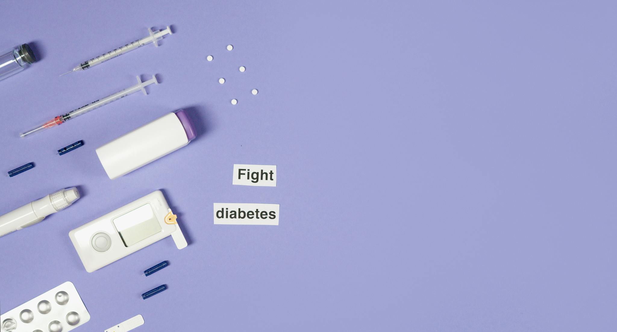 A flat lay of diabetes management tools, including syringes and pills, on a purple background.